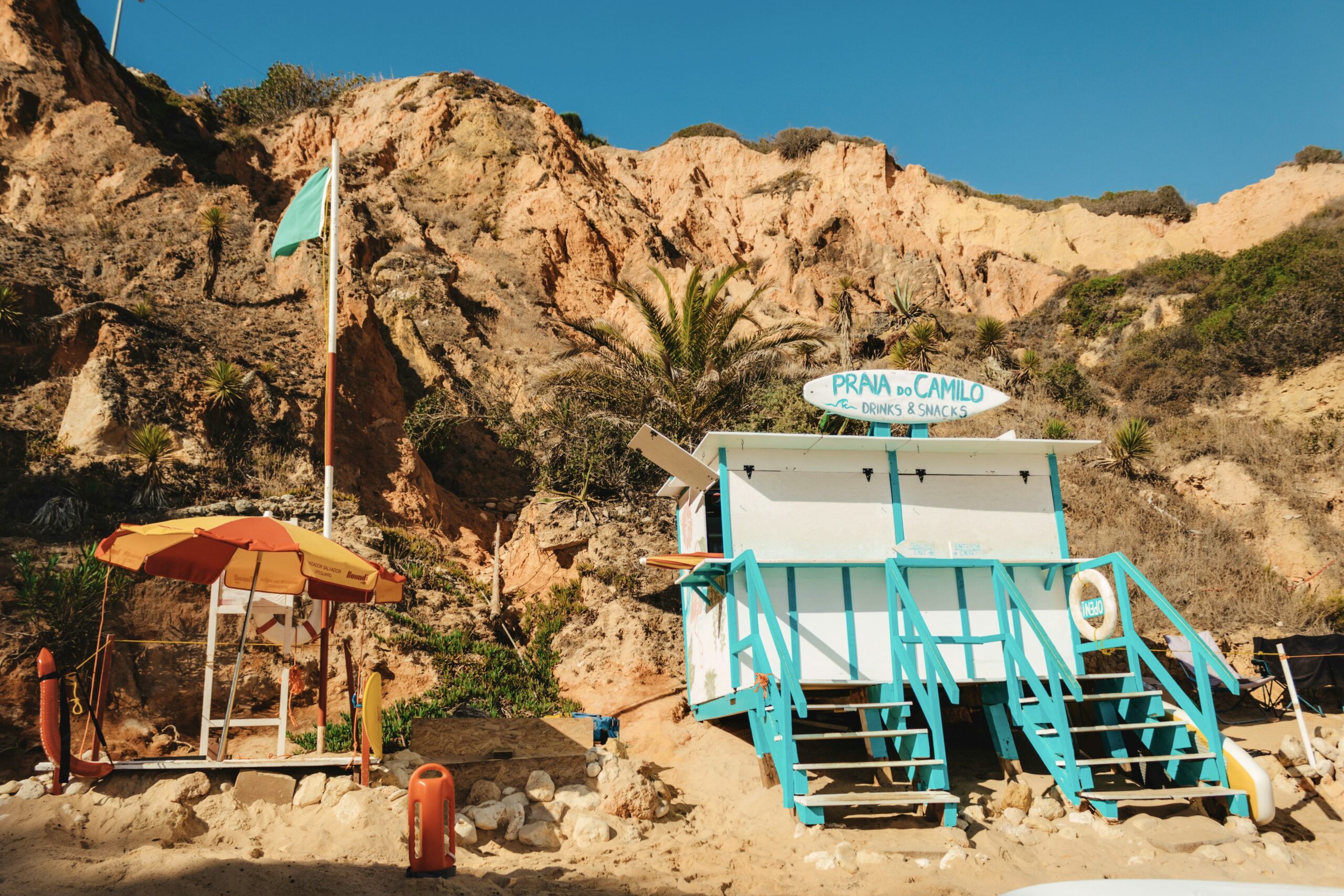 A white and blue beach bar shack on a tranquil Portuguese beach.